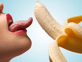 The girl licks a banana